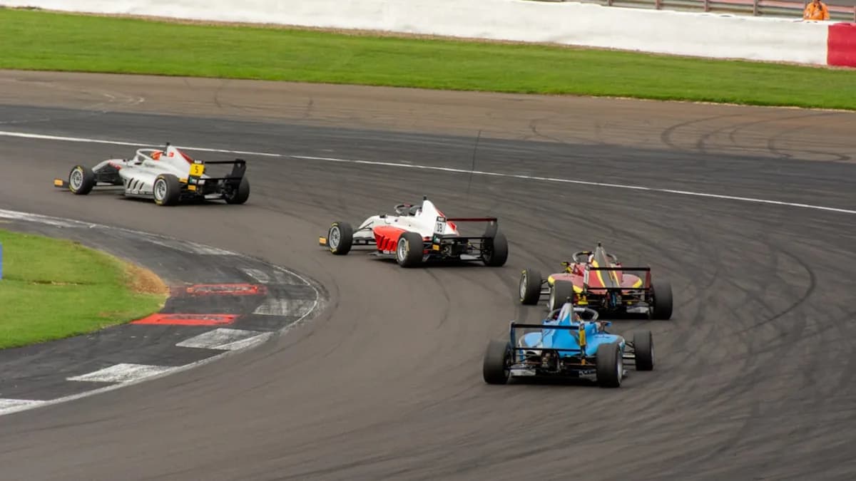 a group of racing cars driving around a track
