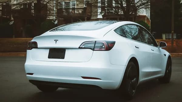 a white tesla parked in a parking lot