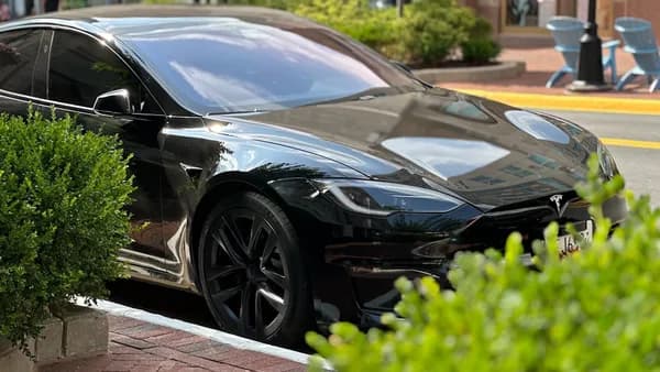 A black car parked on the side of the road