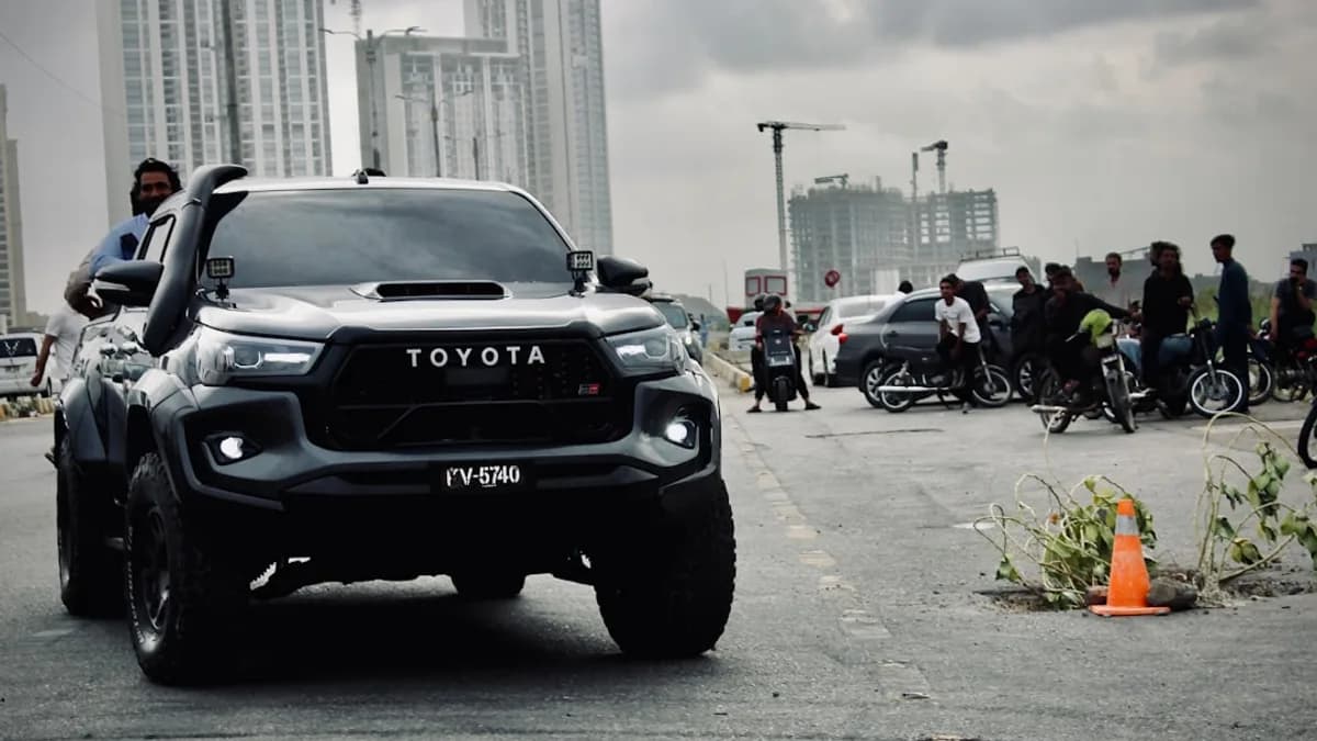 Black toyota truck driving on a city street.