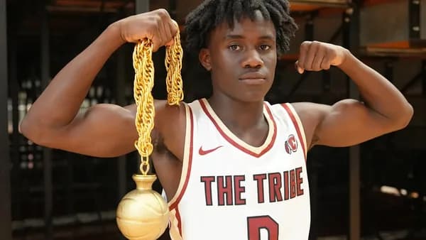 a young man holding a basketball and a golden ball