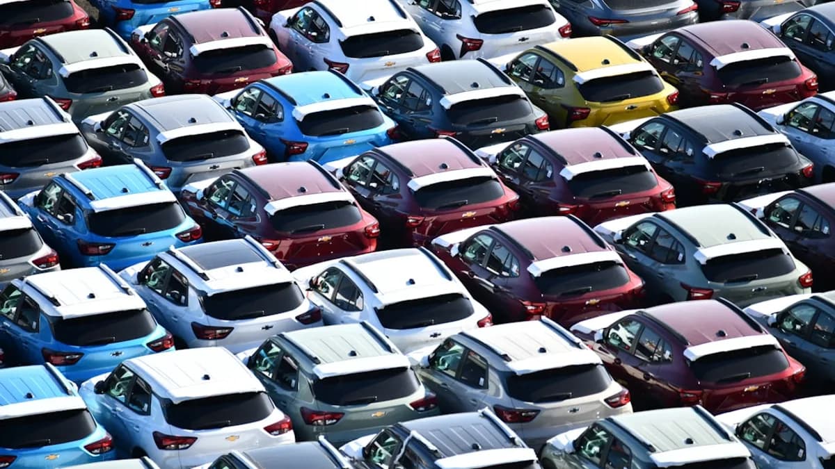 Rows of new cars parked in a large lot