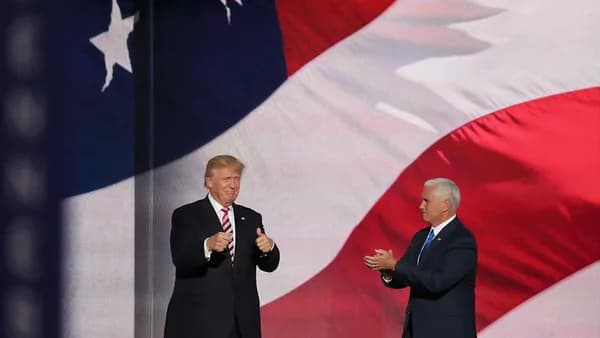 Donald Trump beside man in black suit