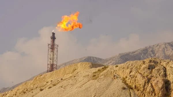 A flare burns brightly from a tower.