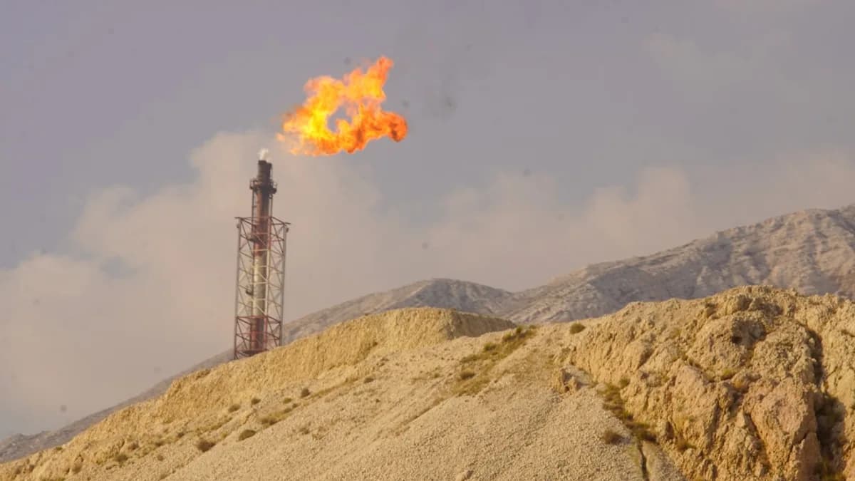 A flare burns brightly from a tower.
