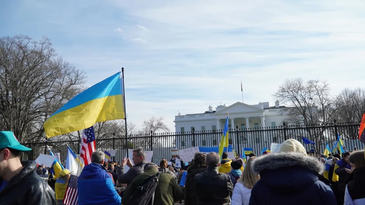a crowd of people standing in front of the white house