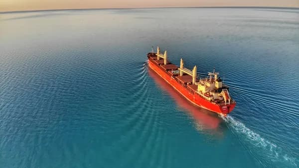 red and white cargo ship at middle of ocean