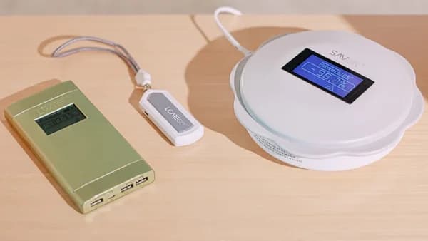 a white device with a screen and a white cord