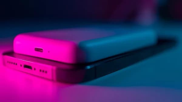a couple of cell phones sitting on top of a table