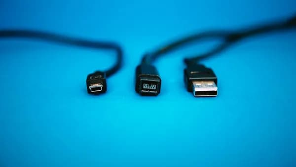 black USB cables on blue surface