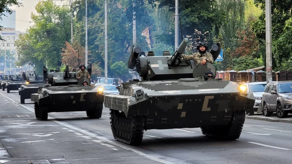A group of tanks driving down a street