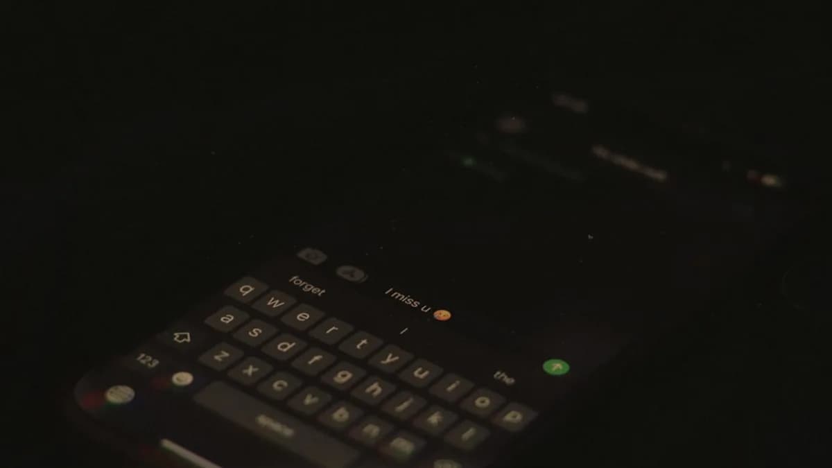 a close up of a cell phone in the dark