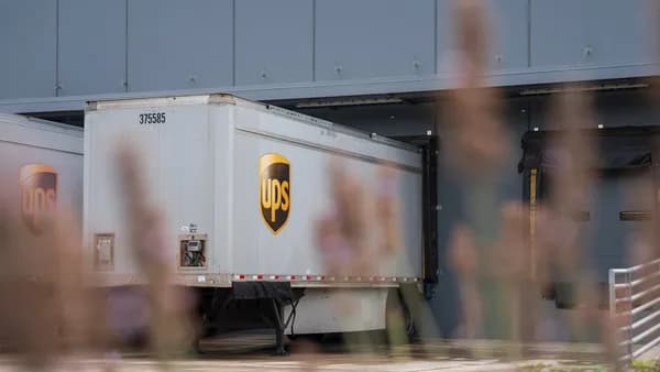 A truck is parked in front of a building