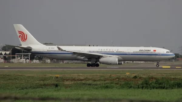 a large jetliner sitting on top of an airport runway