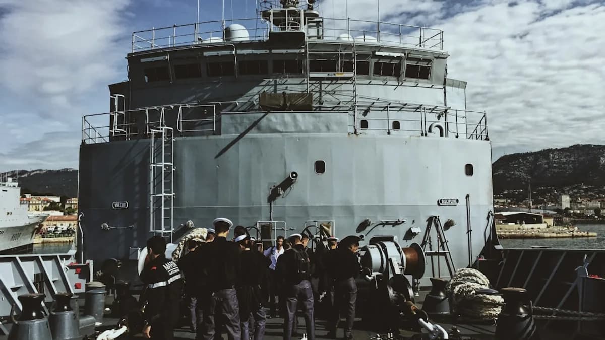 people standing outside round metal tank