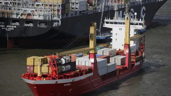 red and white cargo ship beside dock