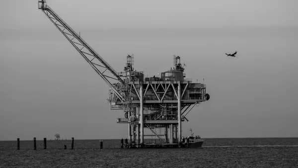 Offshore oil rig with a small plane flying overhead