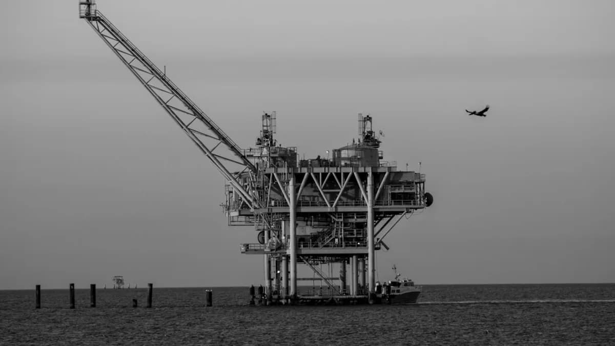 Offshore oil rig with a small plane flying overhead