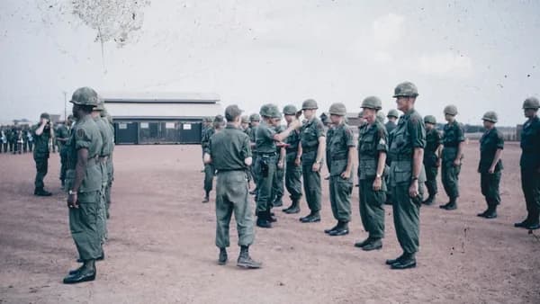 A group of men in military uniforms standing in a circle