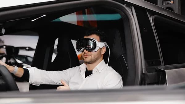 A man sitting in a car wearing a blindfold