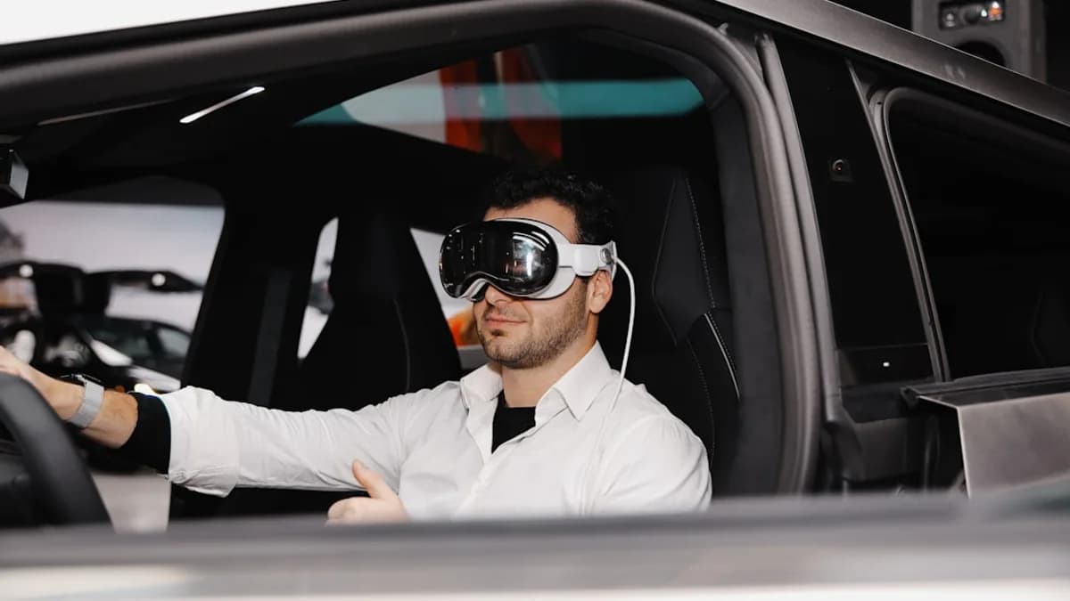A man sitting in a car wearing a blindfold