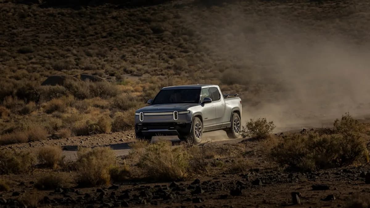 a white truck driving down a dirt road