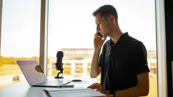 man in black polo shirt sitting at the table