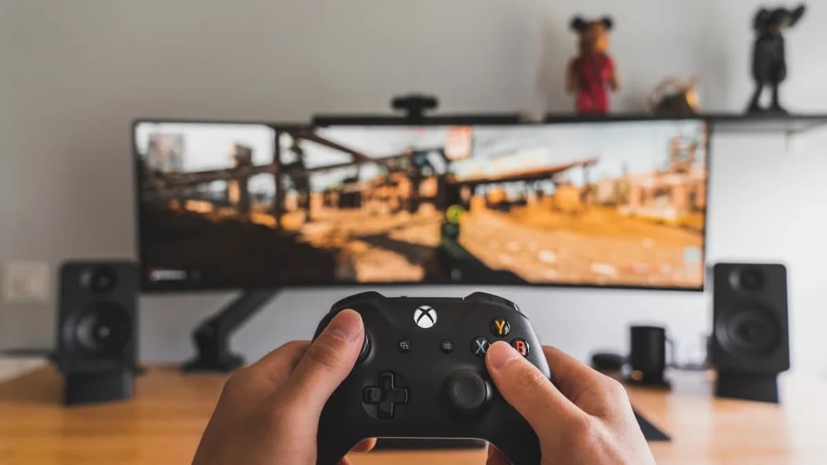 person holding black game controller