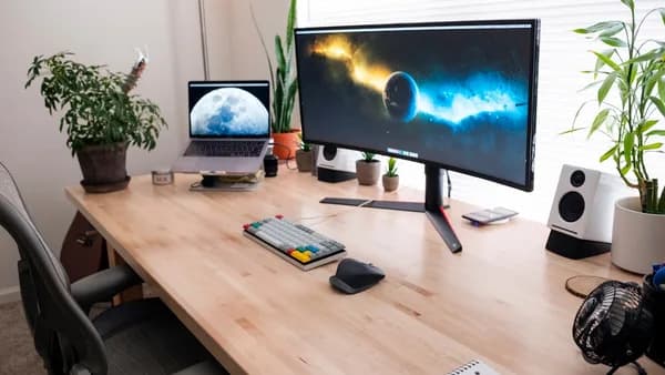 black flat screen computer monitor on brown wooden desk