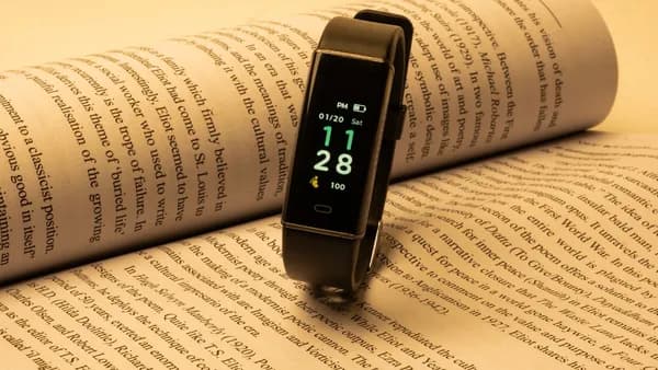 a smart watch sitting on top of an open book