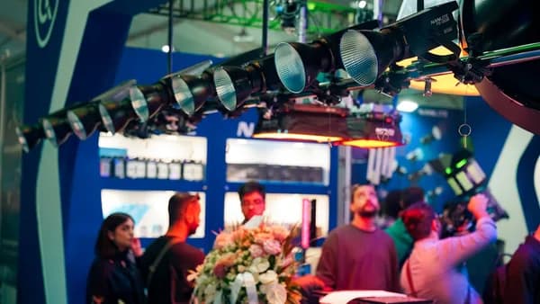 People gather under stage lights at an event