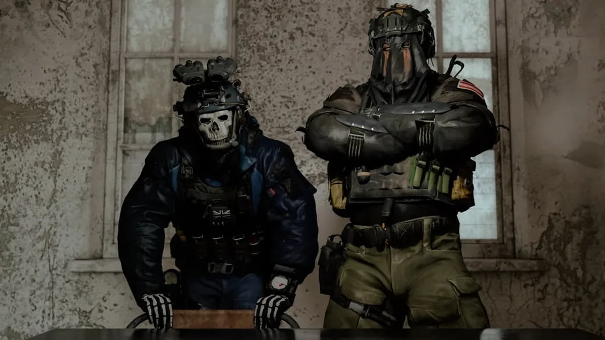 Two soldiers in tactical gear standing indoors.