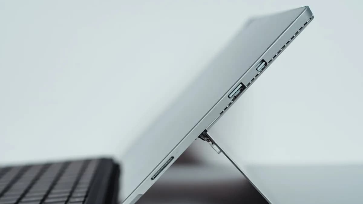black laptop computer on white table