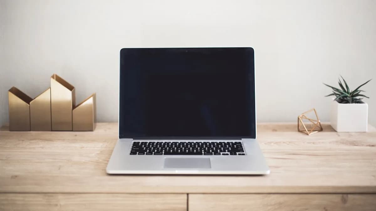 MacBook Pro on top of brown table