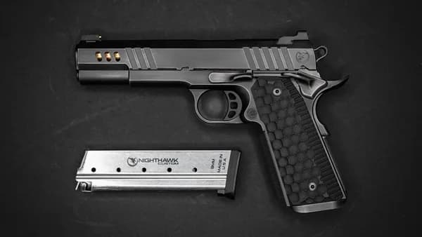 a gun and a knife on a black surface