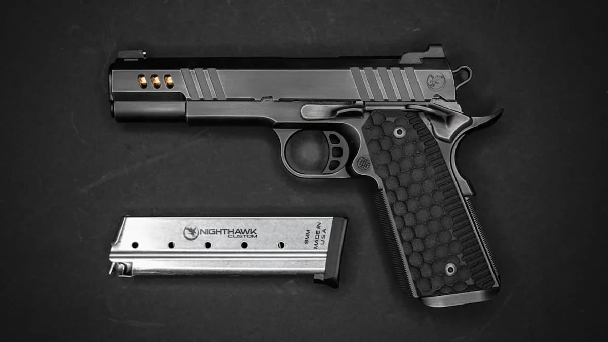 a gun and a knife on a black surface