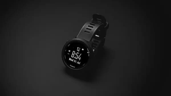 A smart watch sitting on top of a black surface