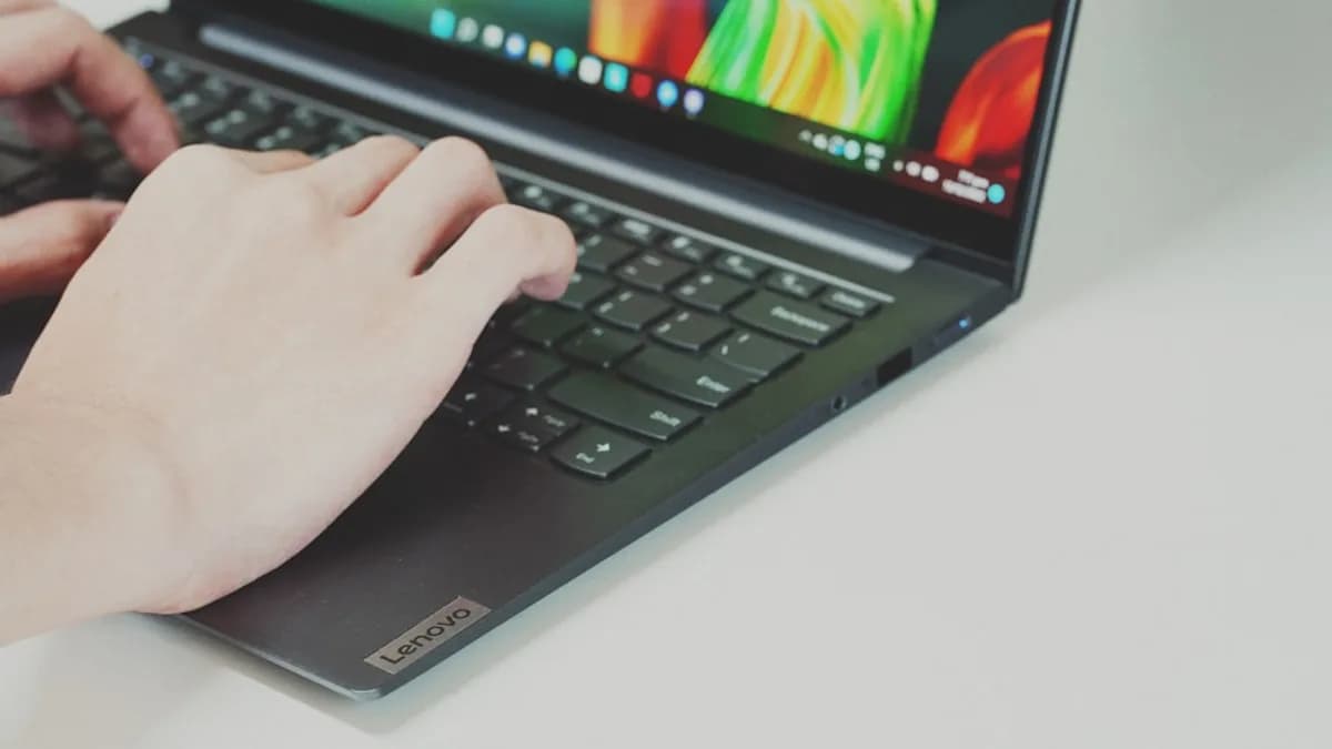 Person typing on a laptop keyboard