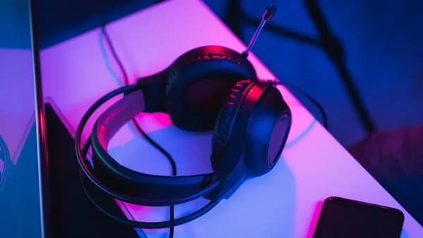 black and red corded headphones on white table