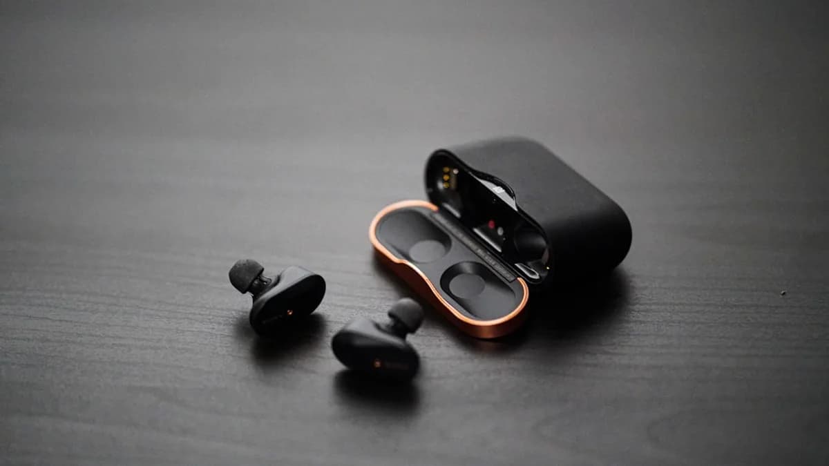 black wireless earphones on surfae