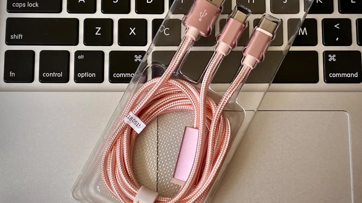a couple of pink cables sitting on top of a laptop