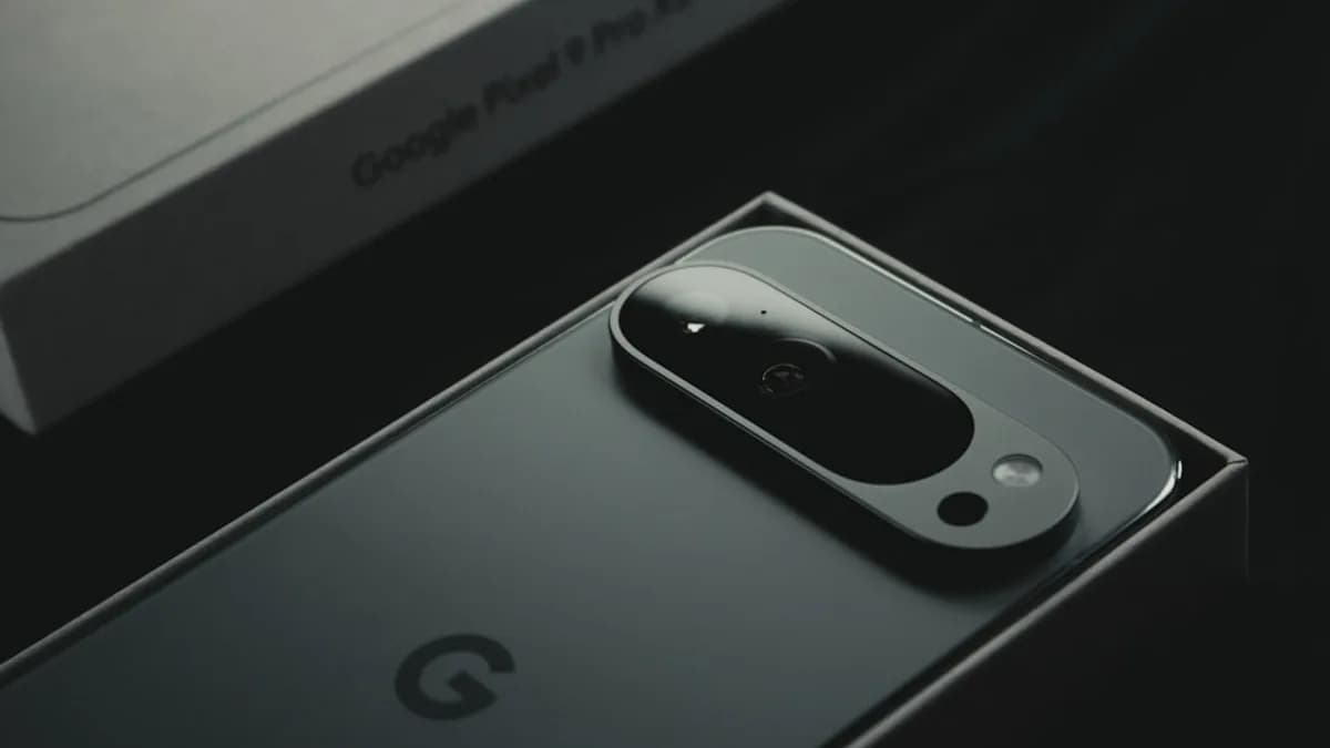 A close up of a cell phone near a laptop