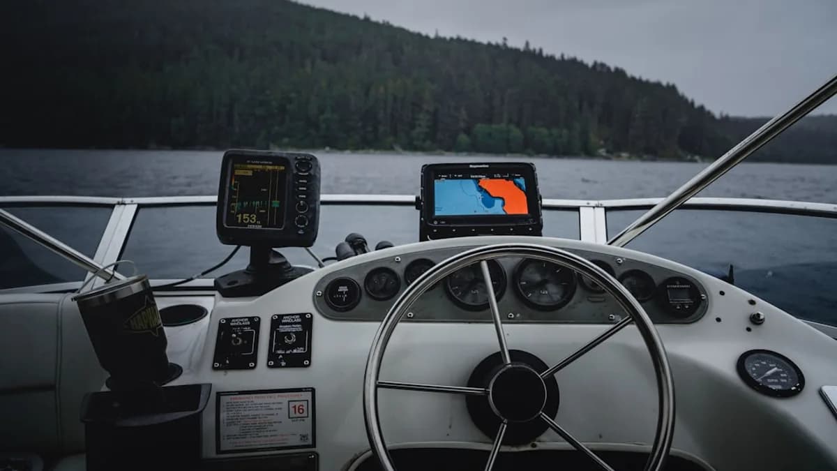 two black fish finders on a fishing boat