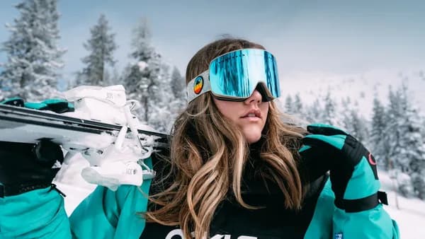 woman in black and white adidas jacket wearing blue sunglasses