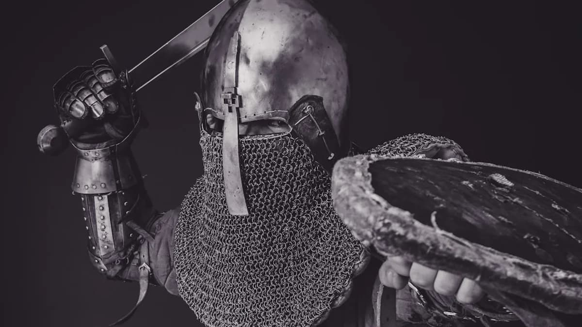 man with steel and chainmail armor holding sword