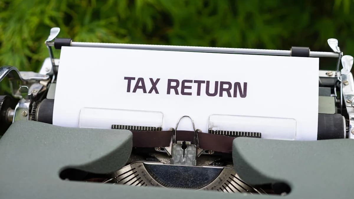 a close up of a typewriter with a tax return sign on it