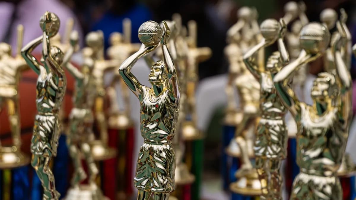 Rows of golden trophies displayed at an event