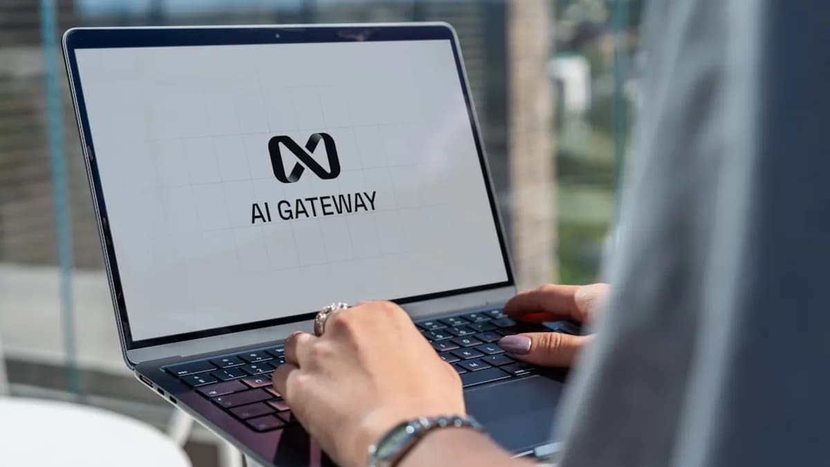 Person typing on laptop with ai gateway logo.