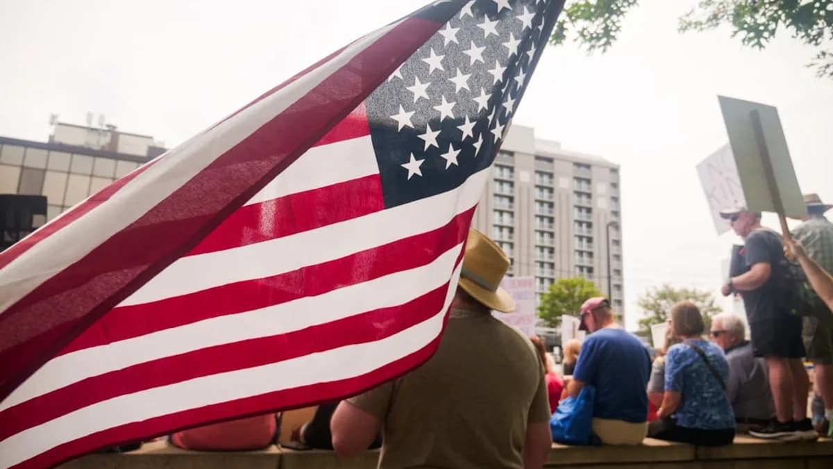 People protest with an american flag.