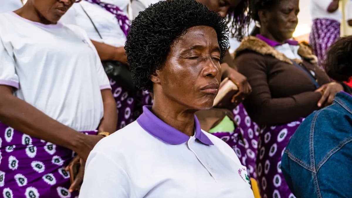 woman wearing white polo shirt closing eyes